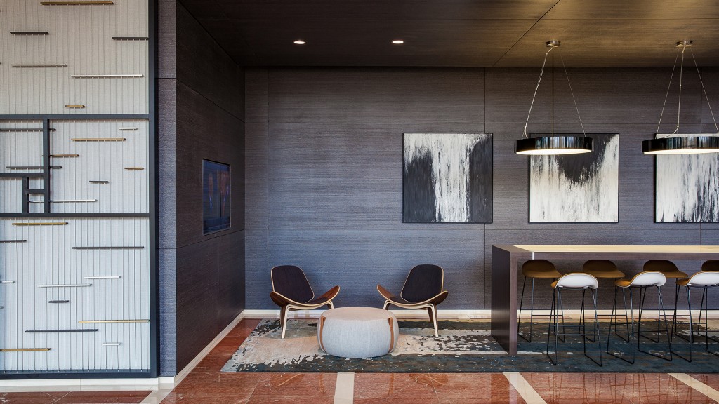 A room with a table chairs and a rug.